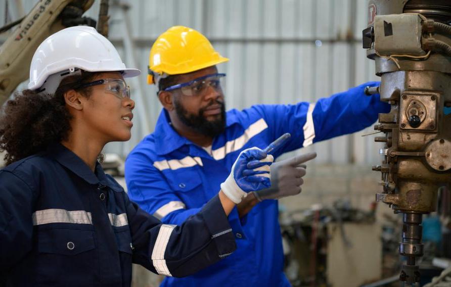 Both of engineers are consulting and exchanging repair experience with each other. about repairing old machines to return to normal operation.